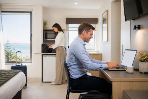 Business travellers working in a self-contained motel room
